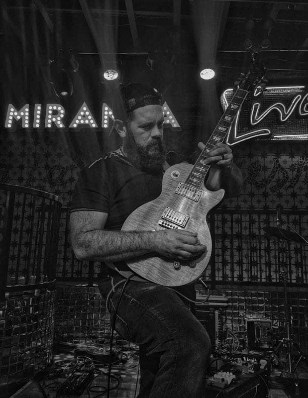 Jon Jimmerson playing guitar on stage